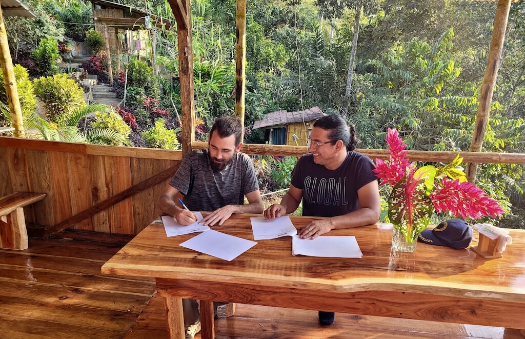 Ryan Lynch and Luis Madrid signing the cooperation agreement